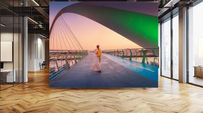 Woman tourist walks on the tolerance suspension bridge in Dubai. Popular travel attractions in the United Arab Emirates Wall mural