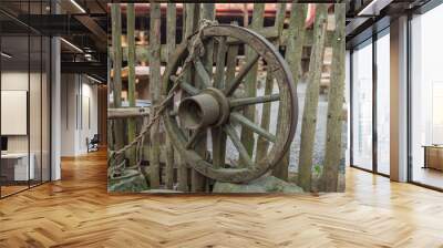 Round from an old farmer's car hanging on a wooden fence in a me Wall mural