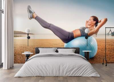 Woman exercising on a pilates ball Wall mural