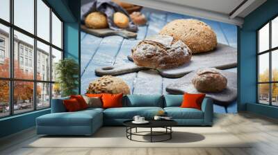 Fresh bread on a blue table in the bakery Wall mural