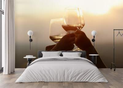 Friends holding glasses of wine at sunset. Chin-chin. Copy space.	
 Wall mural