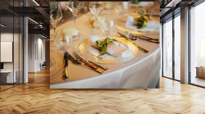 Romantic wedding table arrangement with beige tablecloth and napkins. Wedding table setting close up detail. Restaurant serving on the table close up. Wall mural