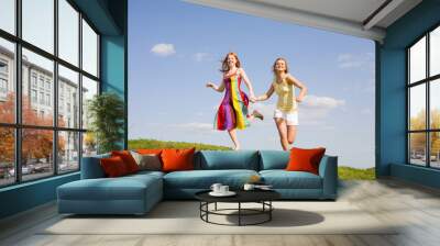 two happy girls jumping Wall mural