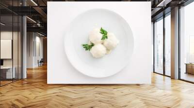 Fish meatball with white sauce and parsley isolated on white background Wall mural