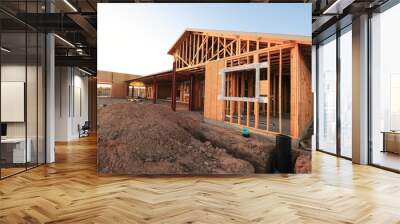 A wide-angle view of a wood frame home under construction  Wall mural