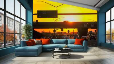 Afternoon traffic is silhouetted by the bright yellow-orange sunset light at Loop 202 and Elliot Road in southeastern Maricopa County, Arizona Wall mural