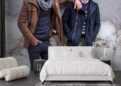 Portrait of two young man posing with fashionable winter clothes Wall mural