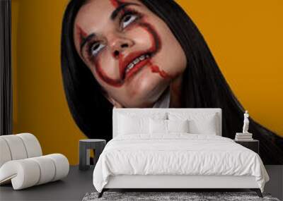 young halloween woman with knife on orange background Wall mural