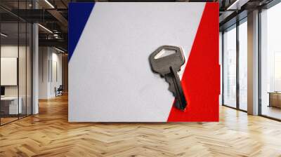 Silver key on the flag of France. Close-up, copy space Wall mural