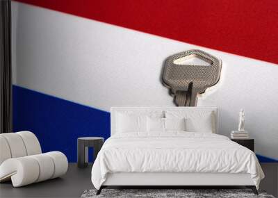 Silver key on the flag of Netherlands. Close-up, copy space Wall mural