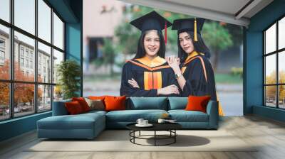 Young charming Asian feemale gradutes cerebrate her degree graduation after accomplish diploma certificate in commencement day. Congratulations on Education achievement Wall mural