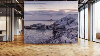 Iced coast river lake during the winter with beautiful sunset and a fantastic sky Wall mural