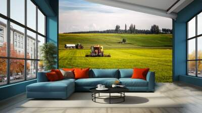 Application of manure on arable farmland with the heavy tractor who works at the field in Germany Wall mural