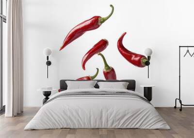 Five red chili peppers floating on white background Wall mural