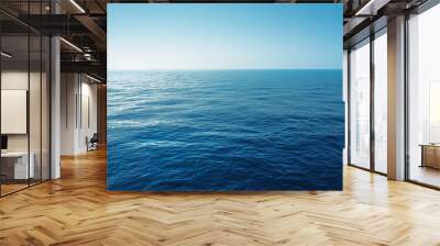 Deep blue ocean water surface meeting clear sky horizon Wall mural