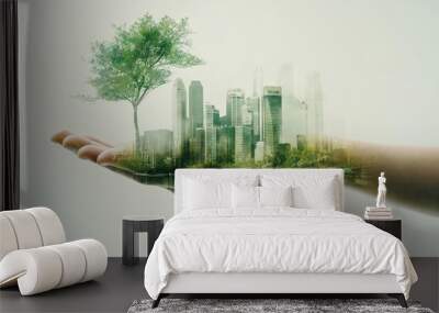 Hand holding sustainable cityscape with lush green trees Wall mural