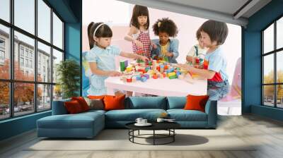 Group of diversity kids playing with colorful blocks on table in class at the kindergarten.Kindergarten international school, education concept. Wall mural