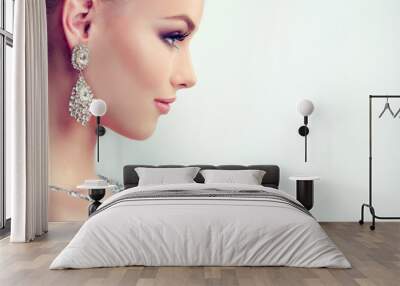 Beautiful girl with evening makeup and  large earrings jewelry . Wall mural