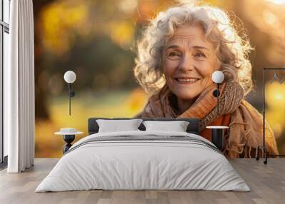 A joyful elderly woman enjoying a sunny day outdoors, with a wide smile and relaxed pose, providing ample copy space above and below for text or design elements Wall mural