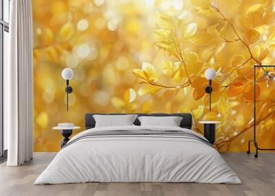 Soft-focus image of sunlight filtering through a canopy of yellow and amber leaves, creating a warm and inviting background reminiscent of crisp autumn days. Wall mural