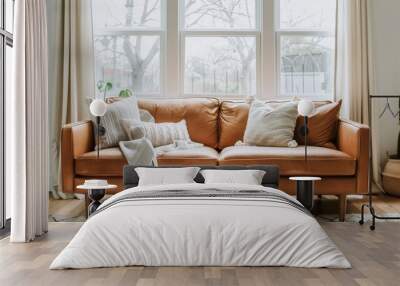 brown leather sofa in front of the window, adorned with boho-inspired pillows and throw blankets on top. Wall mural