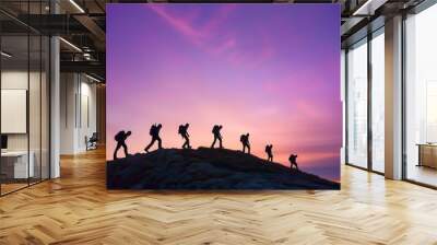 Silhouettes engaged in outdoor activities such as hiking or rock climbing at sunset. Wall mural