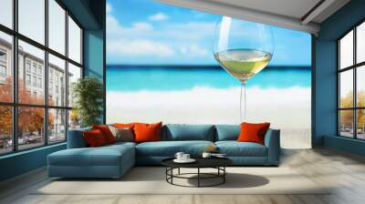 Glass of wine on beach background Wall mural