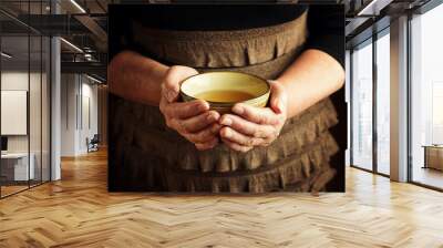 Hands of senior woman holding cup of tea Wall mural