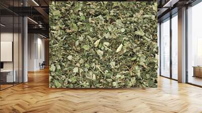 Dried Melissa leaves (Melissa officinalis), also known as lemon balm. Melissa is used as an herb, in teas and also as flavouring. Close up, top view Wall mural