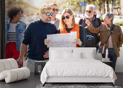 Family friends enjoying together weekend vacation - Group of tourists visiting European city walking on city street  Wall mural