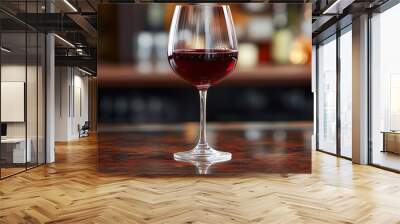 a glass of red wine on the bar table Wall mural