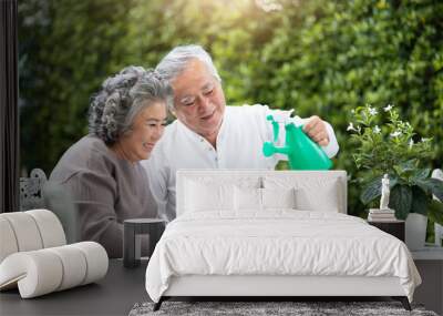 Asian Senior Couple helping to care for plants. Wall mural