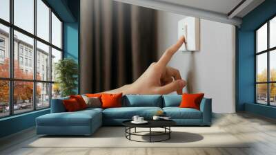 Female finger is turn off on lighting switch Wall mural