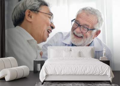 happiness of senior male doctor with asian male patient. Wall mural