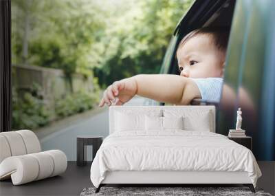 Little Asian boy extend hand outside open window car in holiday, Transportation and travel, Summer vacation Wall mural