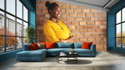 Portrait of African Female Creative Designer in Yellow shirt with Arms Crossed. Wall mural