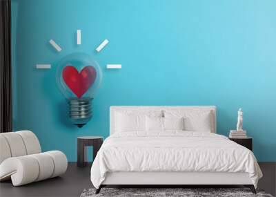 Red heart in light bulb on blue background with copy space. Wall mural