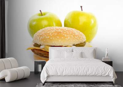 Two healthy apples behind a hamburger Wall mural