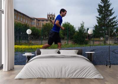 young man running in a park Wall mural