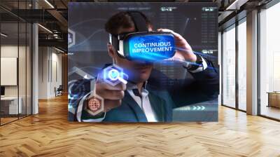 Business, Technology, Internet and network concept. Young businessman working in virtual reality glasses sees the inscription: Continuous improvement Wall mural