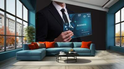 Business, Technology, Internet and network concept. Young businessman working on a virtual screen of the future and sees the inscription: Business Wall mural