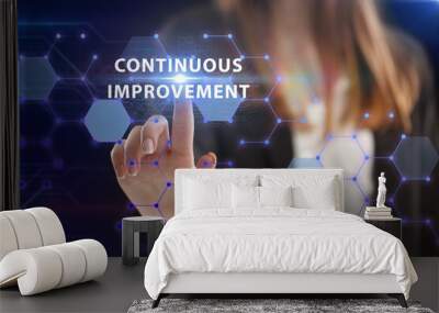 Business, Technology, Internet and network concept. Young businessman working on a virtual screen of the future and sees the inscription: Continuous improvement Wall mural