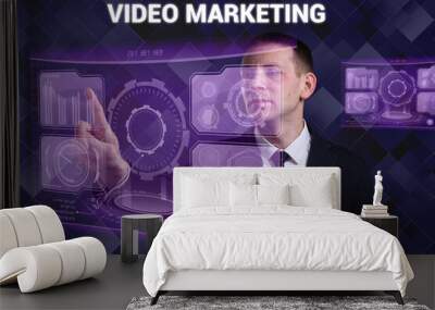 Business, Technology, Internet and network concept. Young businessman working on a virtual screen of the future and sees the inscription: Video marketing Wall mural