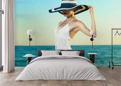 Elegant woman in a hat at sea Wall mural