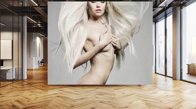 Sexy naked girl with a beautiful body posing in a photo studio. Wall mural