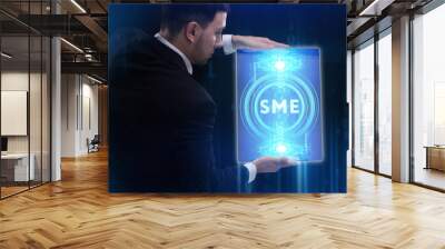 The concept of business, technology, the Internet and the network. A young entrepreneur working on a virtual screen of the future and sees the inscription: SME Wall mural