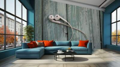 white telephone headphones on a turquoise desktop Wall mural