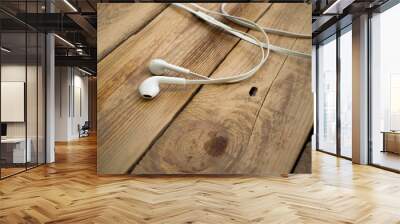 white telephone headphones on a wooden desktop Wall mural