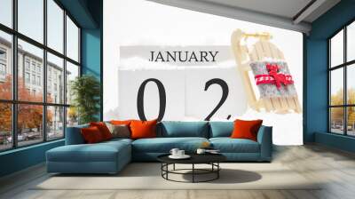 Wooden calendar for January, 2 nd day of the winter month. The symbols of winter are snow and sleigh. Concept of holidays, vacation and winter fun. Wall mural