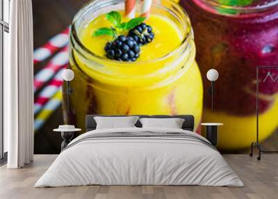 colorful two layer smoothies with mango and berries on rustic wo Wall mural